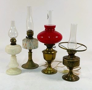 Lot 551 - Four brass and glass oil lamps, with two...