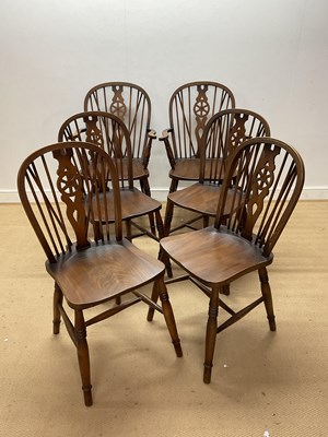 Lot 634 - Four Windsor wheelback stained wood dining...