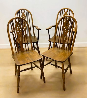 Lot 635 - A pair of Windsor wheelback stained wood...