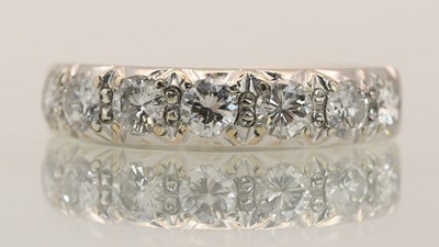 Lot 1370 - An 18ct white gold diamond set ring, with half...