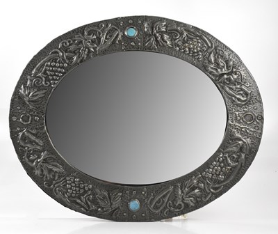 Lot 124 - An Arts and Crafts sheet pewter mirror of oval...
