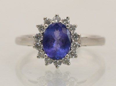 Lot 1440 - A platinum ring with claw set oval tanzanite...