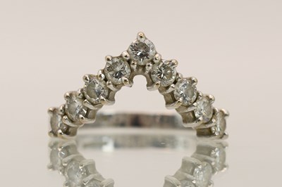 Lot 1387 - An 18ct white gold diamond set wishbone ring,...