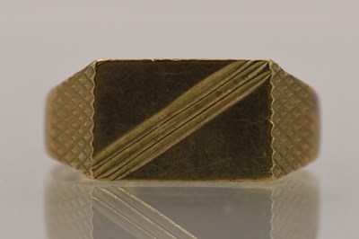 Lot 1419 - A 9ct yellow gold signet ring, with engine...
