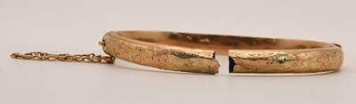 Lot 1546 - A 9ct yellow gold hinged snap bangle, with...