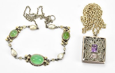 Lot 593 - A sterling silver locket with central ameyst...