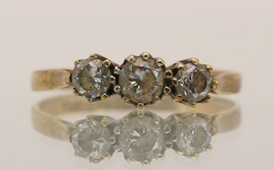 Lot 1452 - A 9ct yellow gold three white stone set ring,...