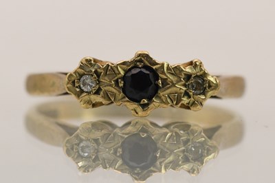 Lot 1454 - A 9ct yellow gold diamond and sapphire set...