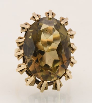 Lot 1441 - A 9ct yellow gold dress ring, set with smoky...