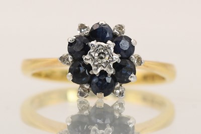 Lot 1426 - An 18ct yellow gold diamond and sapphire...