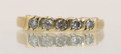 Lot 1427 - A 9ct yellow gold half hoop ring, set with...