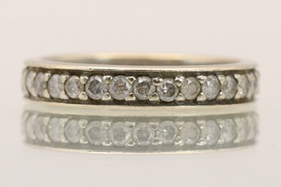 Lot 1428 - A 9ct white gold eternity ring set with tiny...