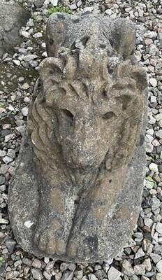 Lot 695 - A composite stone lion, in the prone position,...