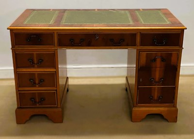 Lot 645 - A reproduction pedestal desk, the top having...