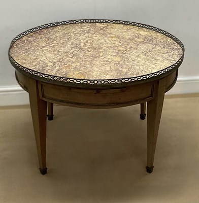 Lot 644 - A circular low occasional table with marble...