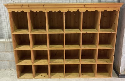 Lot 594 - A pine open storage unit with twenty-four open...