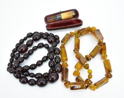 Lot 1594 - Two amber coloured necklaces comprising cherry...