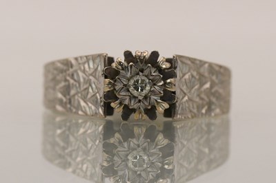 Lot 1414 - An 18ct white gold dress ring, set with tiny...