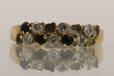 Lot 1450 - A 9ct yellow gold diamond and sapphire dress...