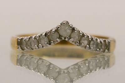 Lot 1449 - A 9ct yellow gold wishbone ring set with small...