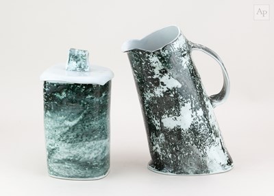 Lot 692 - A leaning porcelain jug covered in carbon trap...