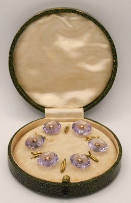 Lot 1350 - A cased set of six amethyst and gold dress...