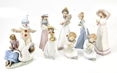 Lot 1305 - NAO; eight ceramic figures including a girl...