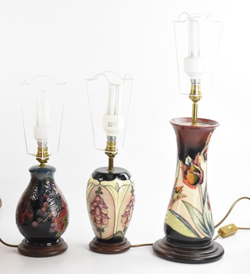 Lot 1243 - MOORCROFT; three contemporary table lamps,...