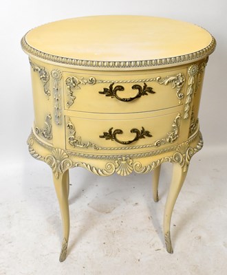 Lot 1740 - A 1950s cream painted oval chest of two drawers