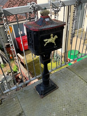 Lot 135 - A cast iron postbox with crown finial, height...
