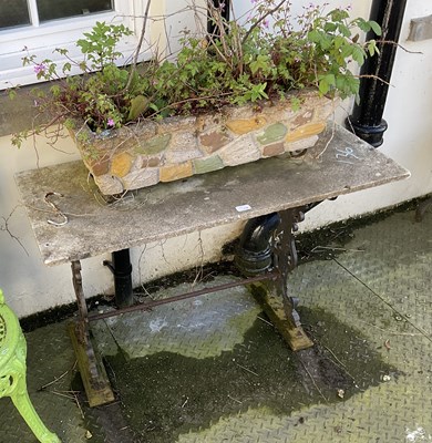 Lot 136 - A cast iron framed garden table with stone top,...