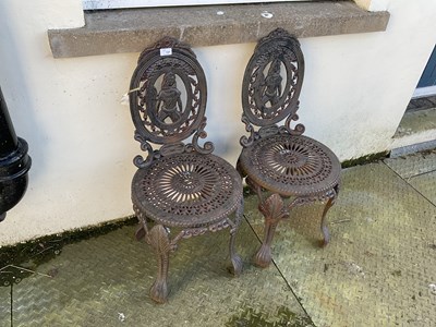 Lot 137 - A pair of reproduction cast iron garden chairs...
