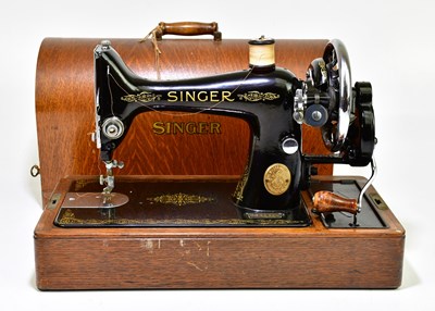 Lot 1148 - An oak cased Singer sewing machine.