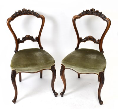 Lot 1598 - A set of four Victorian carved walnut carved dining chairs on carved cabriole supports