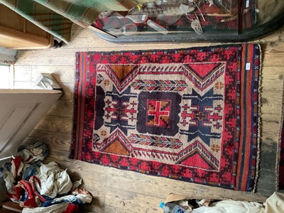 Lot 341 - An Eastern rug with stylised decoration on a...