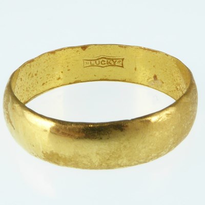 Lot 1029 - A 22ct gold band ring, size P, approx. 3.3g.