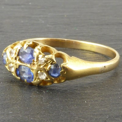 Lot 1113 - An 18ct gold ring with central marquise claw...
