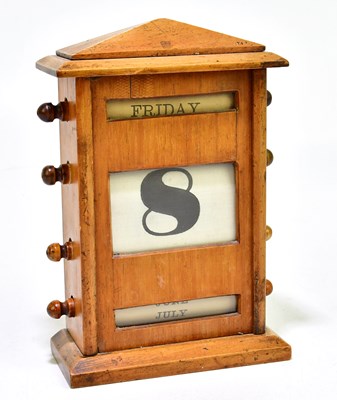 Lot 1009 - An early 20th century oak desk calendar,...
