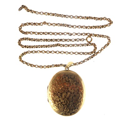 Lot 1231 - A 9ct gold oval double locket with floral...