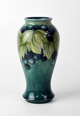 Lot 495 - MOORCROFT; a blue ground baluster vase with...