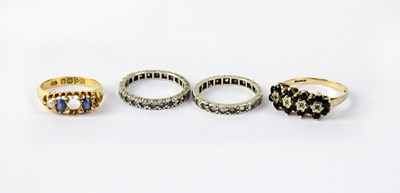 Lot 1119 - Two white metal rings set with small white...