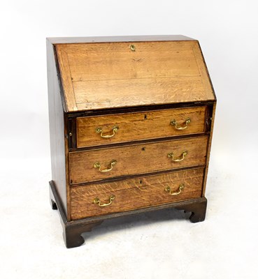Lot 90 - A George III oak bureau with fitted interior,...