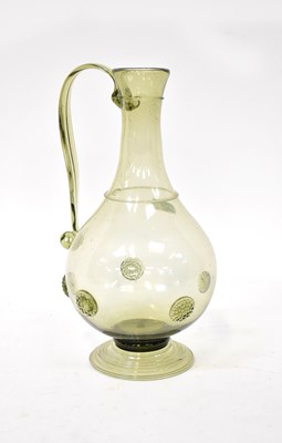 Lot 588 - A 19th century pale green glass jug with...