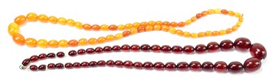 Lot 1237 - A cherry amber coloured bead necklace