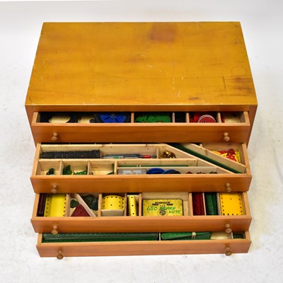 Lot 452 - MECCANO; a four-drawer chest containing...