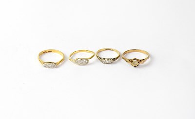Lot 1027 - Two 18ct rings, each with three illusion set...