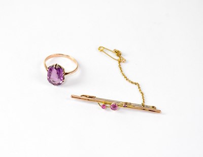 Lot 1200 - A 9ct gold bar brooch set with three pink...