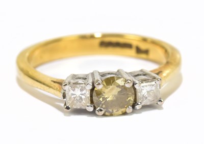 Lot 1245 - An 18ct yellow gold three stone dress ring