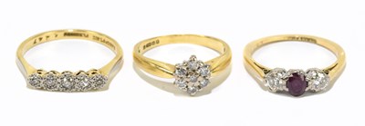 Lot 1252 - An 18ct yellow gold and platinum three stone dress ring
