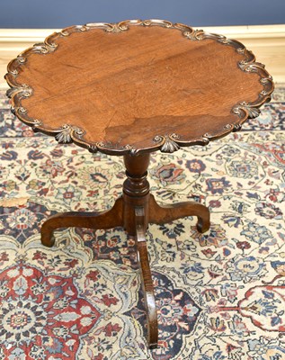 Lot 1677 - An oak piecrust occasional table with shaped...